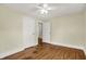 A charming bedroom with light colored walls and trim, hardwood floors, and a ceiling fan at 4447 N College Ave, Indianapolis, IN 46205