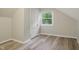Bedroom with light gray walls and wood look flooring and a closet at 4447 N College Ave, Indianapolis, IN 46205