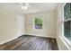 Cozy bedroom with neutral walls, modern flooring, a ceiling fan, and built in shelves at 4447 N College Ave, Indianapolis, IN 46205