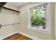 Walk-in closet featuring minimalist shelving for storage and a window for natural light at 4447 N College Ave, Indianapolis, IN 46205