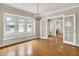 Elegant dining room with hardwood floors, large windows, and a stylish chandelier at 4447 N College Ave, Indianapolis, IN 46205