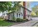 Charming two-story home boasts a brick chimney and well-maintained landscaping at 4447 N College Ave, Indianapolis, IN 46205
