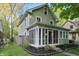 Inviting home showcasing a screened-in porch and manicured garden beds at 4447 N College Ave, Indianapolis, IN 46205