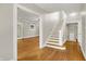 Welcoming foyer with hardwood floors and staircase leading to the upper level at 4447 N College Ave, Indianapolis, IN 46205