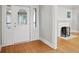 Entryway featuring hardwood floors, decorative door, and fireplace view at 4447 N College Ave, Indianapolis, IN 46205