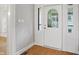 Bright foyer with hardwood floors and decorative front door at 4447 N College Ave, Indianapolis, IN 46205