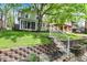 Landscaped front yard with brick retaining wall and steps leading to home's entrance at 4447 N College Ave, Indianapolis, IN 46205