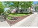 Charming two-story home featuring a well-manicured lawn and a paved driveway at 4447 N College Ave, Indianapolis, IN 46205