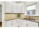 Bright kitchen featuring white cabinets, granite countertops, and stainless steel sink at 4447 N College Ave, Indianapolis, IN 46205
