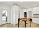 Bright kitchen with white cabinetry, pantry and stainless steel appliances and walk-out to patio at 4447 N College Ave, Indianapolis, IN 46205