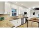 Modern kitchen with stainless appliances, granite counters, a table and ceramic tile floors at 4447 N College Ave, Indianapolis, IN 46205