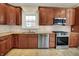 Spacious kitchen features granite countertops, stainless steel appliances and wood cabinets at 4447 N College Ave, Indianapolis, IN 46205