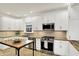 Contemporary kitchen with stainless steel appliances, granite countertops, and bright lighting at 4447 N College Ave, Indianapolis, IN 46205