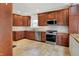 Spacious kitchen features granite countertops, stainless steel appliances and wood cabinets at 4447 N College Ave, Indianapolis, IN 46205