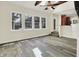 Bright living room with vaulted ceiling, beamed accents and a view of the outdoors through large windows at 4447 N College Ave, Indianapolis, IN 46205