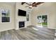 Cozy living room with fireplace, vaulted ceiling with wooden beams, and access to the backyard at 4447 N College Ave, Indianapolis, IN 46205