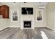 Living room showcasing a fireplace, a wall-mounted television, and two windows allowing natural light at 4447 N College Ave, Indianapolis, IN 46205