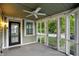 Cozy screened porch with ceiling fan, and entrance door at 4447 N College Ave, Indianapolis, IN 46205