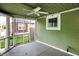 Enclosed porch featuring concrete flooring, fan, and natural light at 4447 N College Ave, Indianapolis, IN 46205