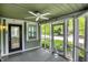 Relaxing screened porch with ceiling fan and views of the street at 4447 N College Ave, Indianapolis, IN 46205