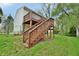 Two-tier wooden deck extends into the backyard, ideal for outdoor living and entertaining with natural light at 4527 Peachwood Ct, Indianapolis, IN 46235