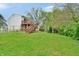 Expansive backyard with a wooden deck, ideal for outdoor dining and enjoying the natural surroundings at 4527 Peachwood Ct, Indianapolis, IN 46235