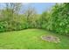 Spacious backyard with a fire pit and lush greenery, perfect for outdoor entertaining and relaxation at 4527 Peachwood Ct, Indianapolis, IN 46235