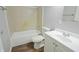 Bright bathroom with tile surround, modern sink, and hardwood floors at 4527 Peachwood Ct, Indianapolis, IN 46235