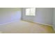 Cozy bedroom featuring neutral-toned walls, soft carpet, and a sunlit window at 4527 Peachwood Ct, Indianapolis, IN 46235