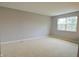 Bright bedroom with neutral walls, plush carpeting, and a large window, creating a serene and comfortable space at 4527 Peachwood Ct, Indianapolis, IN 46235