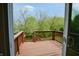 View of a deck overlooking a lush green backyard with mature trees, a serene outdoor space at 4527 Peachwood Ct, Indianapolis, IN 46235