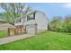 Split-level home with attached garage, set back from the street with a front yard and mature trees at 4527 Peachwood Ct, Indianapolis, IN 46235