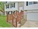 Inviting entrance with brick accents and a wooden porch, leading to the main door of the home at 4527 Peachwood Ct, Indianapolis, IN 46235