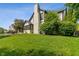 Back exterior view showcasing the home's architecture and well-maintained lawn at 4601 Fairhope Dr, Indianapolis, IN 46237