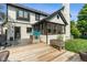 View of a house's backyard featuring a wood deck, a small playhouse, and green space at 4601 Fairhope Dr, Indianapolis, IN 46237