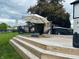 Multi-level deck offers stylish seating, an umbrella for shade, and a relaxing hot tub, perfect for outdoor enjoyment at 4601 Fairhope Dr, Indianapolis, IN 46237