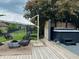 Inviting backyard deck features comfortable seating around a modern fire pit and a relaxing hot tub for ultimate leisure at 4601 Fairhope Dr, Indianapolis, IN 46237