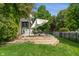 Landscaped backyard featuring a tiered deck with seating area and lush green lawn at 4601 Fairhope Dr, Indianapolis, IN 46237