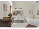 Elegant bathroom with a freestanding tub, double vanity, and modern fixtures at 4601 Fairhope Dr, Indianapolis, IN 46237