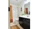 Well-lit bathroom features a shower-tub, dark vanity, and decorative elements at 4601 Fairhope Dr, Indianapolis, IN 46237