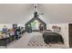 This bedroom features two arcade machines, a large ceiling fan and an angled roof at 4601 Fairhope Dr, Indianapolis, IN 46237