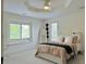Bright bedroom with a cozy bed and an interesting tray ceiling with a fan at 4601 Fairhope Dr, Indianapolis, IN 46237