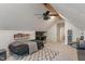 This bedroom features built in shelving, an angled roof and a large ceiling fan at 4601 Fairhope Dr, Indianapolis, IN 46237