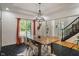 Dining room featuring black tile floors, a wooden table, and large windows at 4601 Fairhope Dr, Indianapolis, IN 46237
