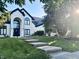 Charming two-story home with a manicured lawn and mature trees surrounding the property at 4601 Fairhope Dr, Indianapolis, IN 46237