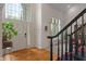 Elegant foyer with hardwood floors, a grand staircase, and a bright, welcoming atmosphere at 4601 Fairhope Dr, Indianapolis, IN 46237