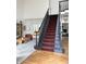 Open foyer with a beautiful staircase and views into the living and dining areas at 4601 Fairhope Dr, Indianapolis, IN 46237