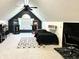 Finished attic game room with natural light, vintage arcade games, and playful decor at 4601 Fairhope Dr, Indianapolis, IN 46237