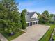 Aerial view of the house showcasing a four car garage and neatly kept landscaping at 4601 Fairhope Dr, Indianapolis, IN 46237