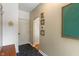 Hallway featuring black hexagon tile, arched doorway, and convenient hall tree at 4601 Fairhope Dr, Indianapolis, IN 46237